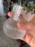 Edinburgh Crystal whisky glass held in hand showing diamond-cut base and etched bowl