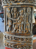 Close-up of a cast metal relief panel on the scabbard depicting several robed Roman figures in conversation.