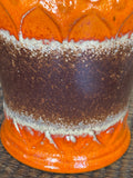 Close-up of orange and brown drip glaze texture on West German pottery jug