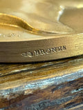 Close-up of medallion edge showing BRONZE stamp and cornucopia Paris Mint mark