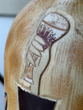 Close-up of raised hand and cuff detail from the Art Deco figure design on ceramic bottle.