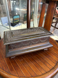 Crawford's biscuit tin c.1925 in bronze effect, shaped as a casket with embossed fruit swags on four bracket feet