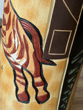 Close-up of zebra legs and hooves in relief on ceramic bottle, with geometric border detail.
