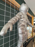 Side view of vintage astronaut wall sculpture designed to appear floating