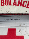 Close-up of Made in Japan text on rear window area of vintage 1960s tinplate ambulance toy