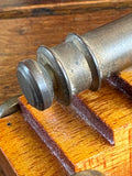 Rear view of miniature brass cannon showing cascabel detail