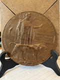 WWI bronze memorial plaque named to James William Sanders, in wooden stand