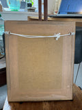 Reverse of framed photograph showing hanging cord and fittings