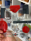 Vintage Martini glass tray held upside down showing the printed logo and red geometric shapes