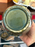 Base of an English art pottery vase with impressed ENGLAND mark, showing glaze wear and small nicks to the foot rim