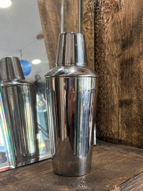 Vintage Kinox stainless steel cocktail shaker on wooden shelf