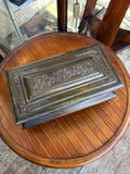 Hinged lid of a Crawford's biscuit tin embossed with classical horsemen in the manner of the Parthenon frieze