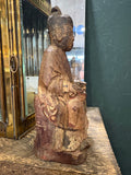 Side profile of antique Chinese carved wood seated official figure