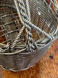Close-up of twisted rope handle and braided rim