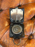 Compass open, showing dial and magnetic needle