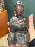 	Antique Chinese carved wood Guanyin figure held in hand to show scale