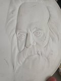 Close-up of Karl Marx profile on white Dresden porcelain medallion