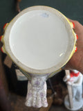 Underside of vintage Lomonosov porcelain head vase, showing factory mark and hand-painted floral handle detail
