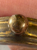 Close-up of suspension loop on brass button compass