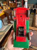 Underside of Wells-Brimtoy 1950s tinplate clockwork truck showing original wire wind-up mechanism and gear train