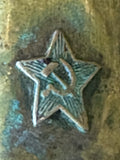 Close-up of Soviet star with hammer and sickle on vintage lighter