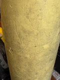 Mid-section detail of large Soviet-era artillery shell replica showing olive green painted finish and surface patina