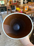 Close-up view down into vase showing dark glazed interior