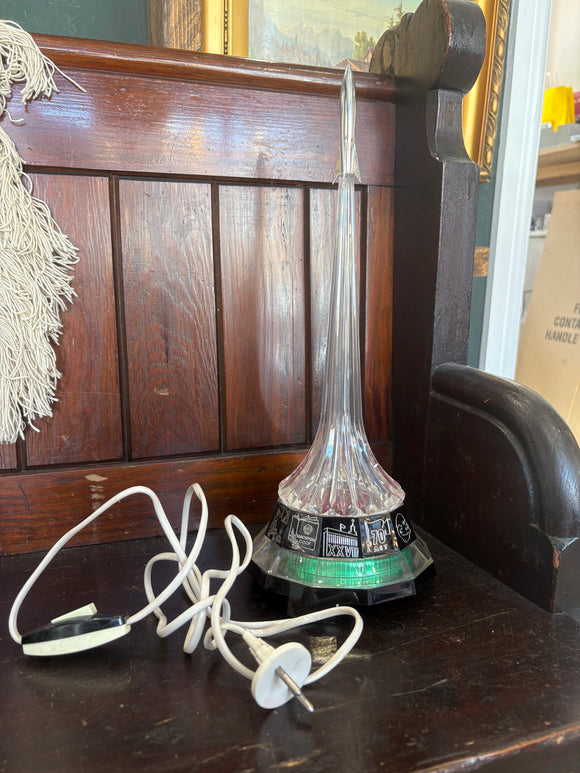 1980s Soviet rocket night light with USSR-themes base, glowing plastic tower, and silver rocket top. 