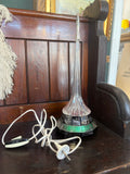 1980s Soviet rocket night light with USSR-themes base, glowing plastic tower, and silver rocket top. 