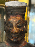 Close-up of smiling painted face and flat-topped hat on antique Chinese figure