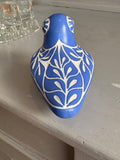 Top view showing decorative white patterns on blue ceramic bird