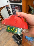 Hand holding rear of Gescha R-558 red tinplate Porsche 356 toy car showing Western Germany licence plate