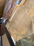 Close-up detail of the upper left reverse of the Victorian portrait frame showing aged and torn brown paper backing, frame timber construction, and the metal ring fixing for the hanging cord.