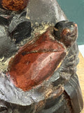 Detail of red-lacquered swaddled infant on antique Chinese Guanyin figure