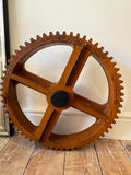 Vintage wooden cog wheel pattern with industrial gear teeth