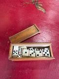 Overhead view of open domino box with tiles and sliding lid
