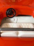 Close-up of steering wheel, pedals and seat detail inside Tonka buggy.