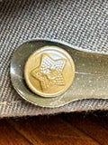 Close-up of a brass star button securing the olive chinstrap on a Soviet officer's peaked cap