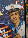 Close-up of Soviet sailor figure on propaganda poster showing white naval cap with Voyenno-Morskoy Flot inscription, gold badge, striped telnyashka and Komsomol badge on uniform