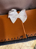 White ribbon bow on the tan sweatband inside an RAF airman's service dress peaked cap