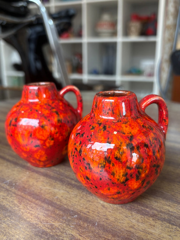 Pair of miniature West German pottery vases with fiery mottled glaze, mid-century decor.