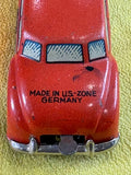 Close-up rear of US-Zone Germany tin litho toy car showing Made in US-Zone Germany text stamp clearly