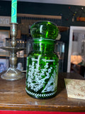 Green glass apothecary jar with white herb design, vintage Belgian, front view