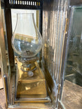 Close-up of brass oil font, burner and chimney inside lantern