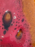Extreme close-up of West German Fat Lava vase glaze showing dark craters and bubbled texture in detail.