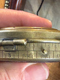 Close-up of compass edge showing degree markings and compass point abbreviations