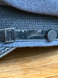 Close-up of the black patent chinstrap, sliding buckle and side button on an RAF service dress cap