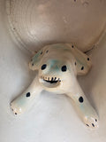 Close-up overhead view of the spotted ceramic frog figure inside an antique Staffordshire surprise mug