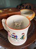 Looking down into an antique Staffordshire frog mug showing the hidden ceramic frog figure inside