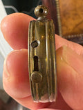 Side view of compass case showing hinge pin and catch